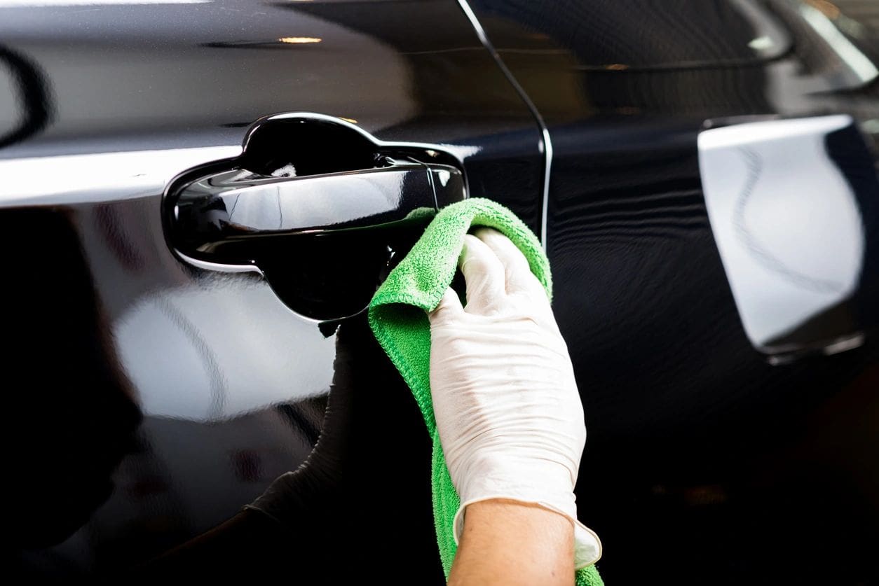 A person cleaning the inside of their car.